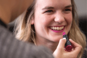 Beauty school student applying makeup to a customer