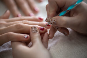 Students performing manacures and pedicures to customers